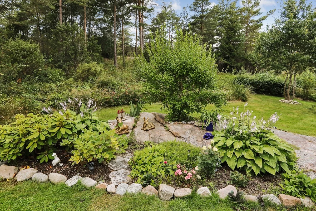 Grönskande och prunkande trädgård och omgivningar gör här extra trivsamt
